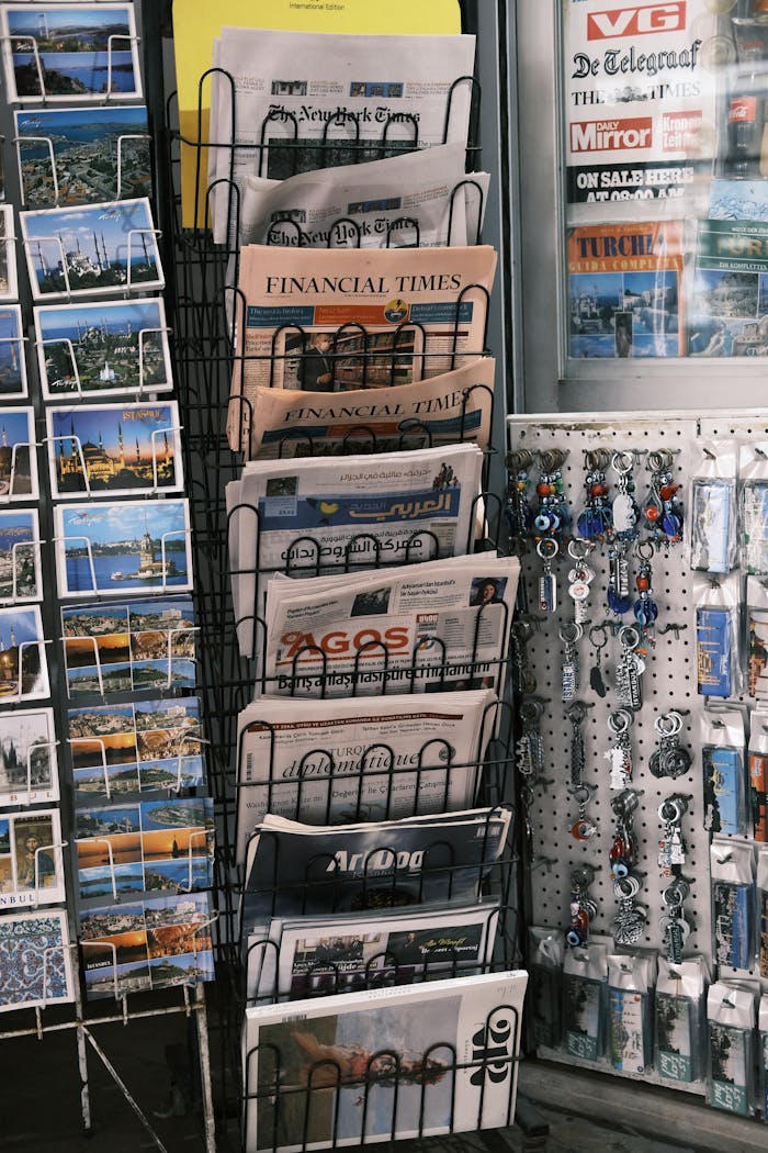 A retail display of international newspapers, postcards, and souvenirs in Istanbul, Turkey.